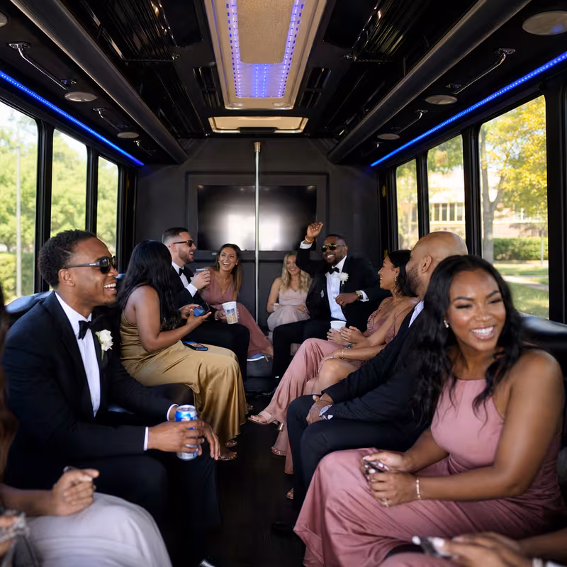 Wedding guests seated inside a Greensboro party bus