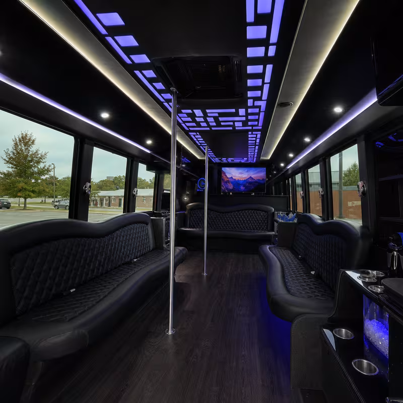 Party bus interior with wraparound leather seating and LED lighting in Greensboro