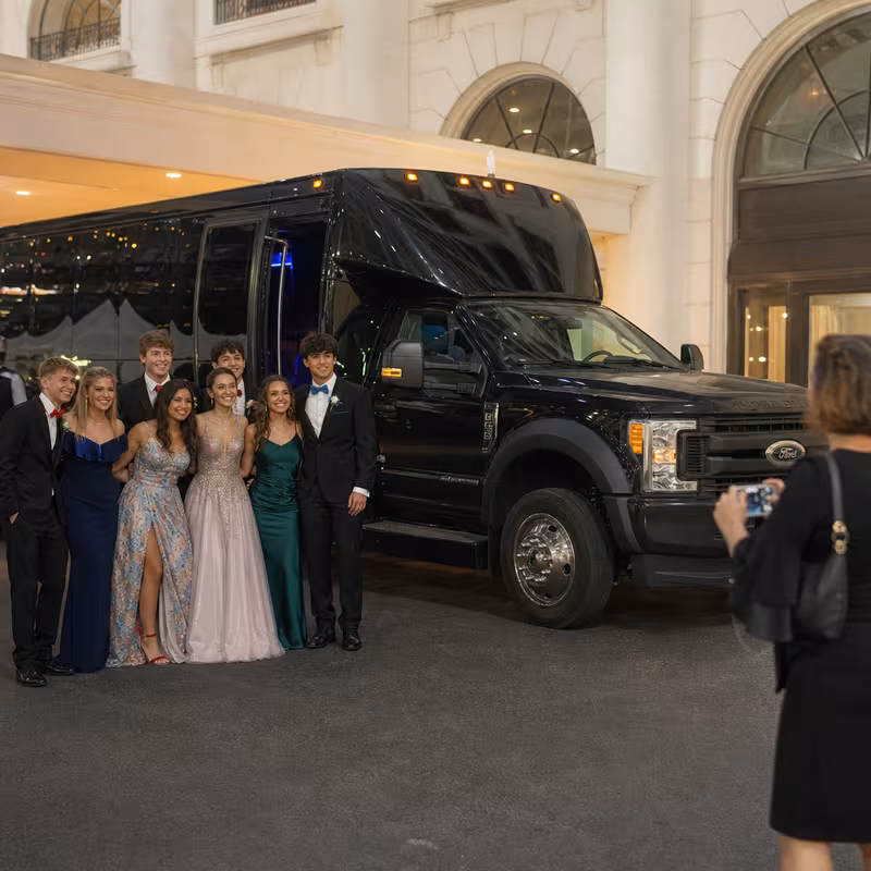 Party bus interior with wraparound leather seating and LED lighting in Greensboro