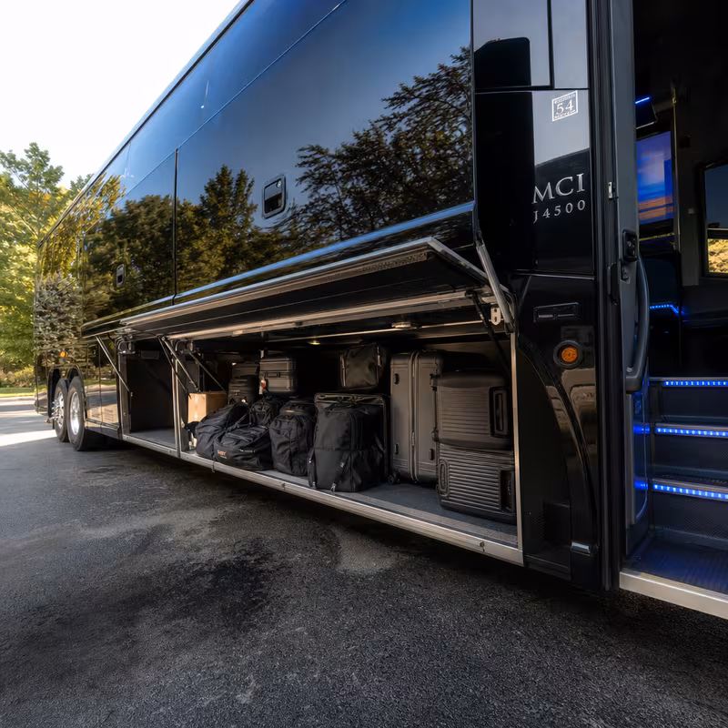 Party bus interior with wraparound leather seating and LED lighting in Greensboro