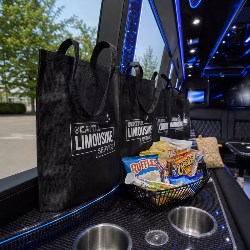 Party bus interior with wraparound leather seating and LED lighting in Greensboro